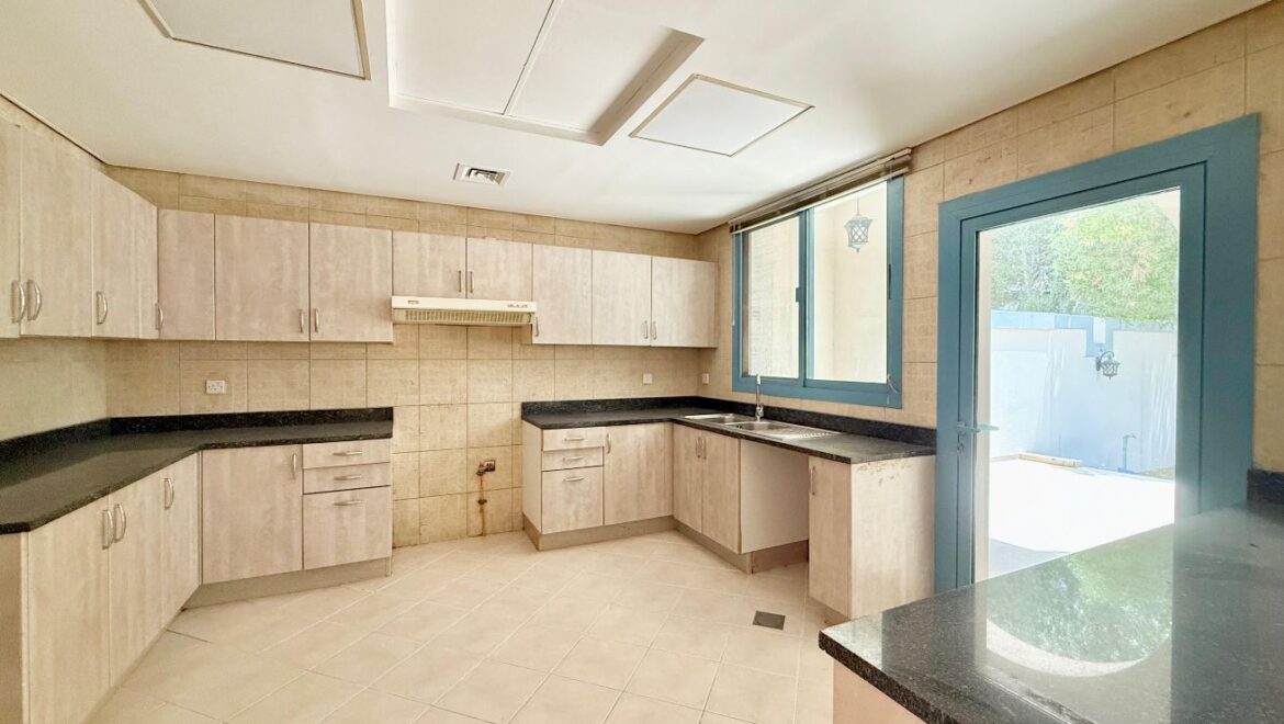 Exterior view of a four-bedroom Aegean-style villa in Western Residence North, Falcon City of Wonders, Dubai, featuring modern architecture and lush landscaping.-Propertyana real estate in dubai and sharjeh