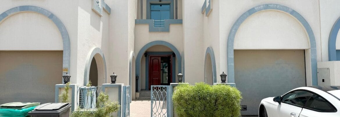 Exterior view of a four-bedroom Aegean-style villa in Western Residence North, Falcon City of Wonders, Dubai, featuring modern architecture and lush landscaping.-Propertyana real estate in dubai and sharjeh