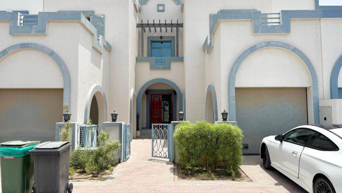 Exterior view of a four-bedroom Aegean-style villa in Western Residence North, Falcon City of Wonders, Dubai, featuring modern architecture and lush landscaping.-Propertyana real estate in dubai and sharjeh