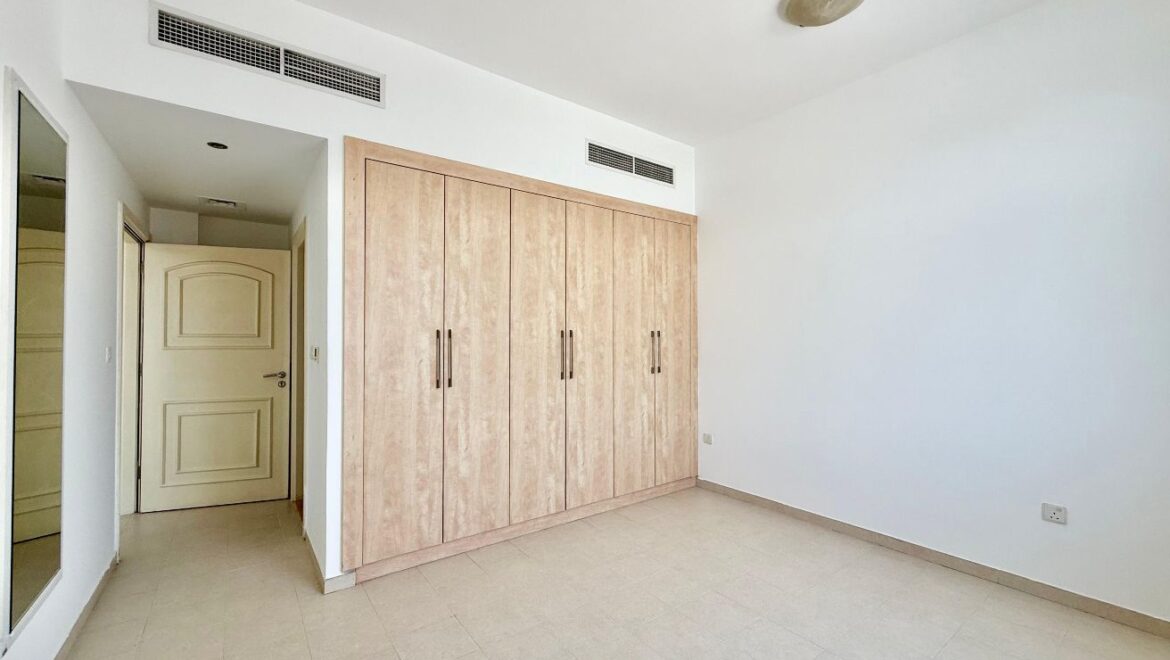 Exterior view of a four-bedroom Aegean-style villa in Western Residence North, Falcon City of Wonders, Dubai, featuring modern architecture and lush landscaping.-Propertyana real estate in dubai and sharjeh