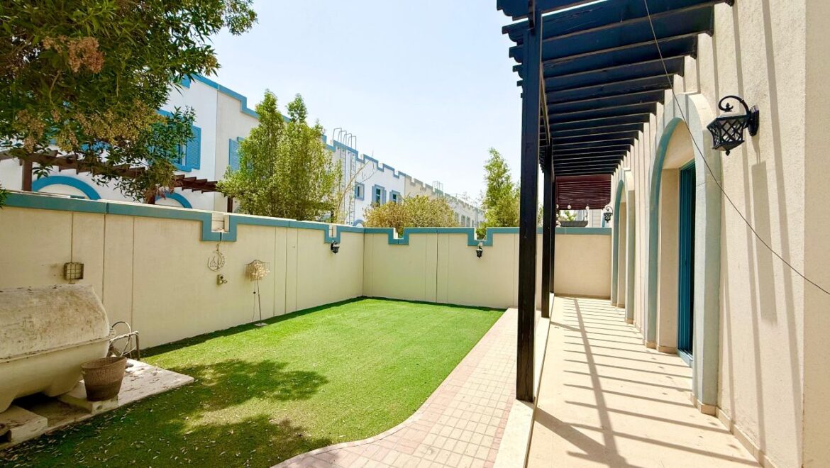 Exterior view of a four-bedroom Aegean-style villa in Western Residence North, Falcon City of Wonders, Dubai, featuring modern architecture and lush landscaping.-Propertyana real estate in dubai and sharjeh