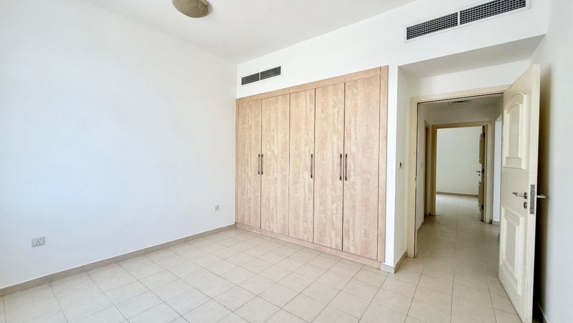 Exterior view of a four-bedroom Aegean-style villa in Western Residence North, Falcon City of Wonders, Dubai, featuring modern architecture and lush landscaping.-Propertyana real estate in dubai and sharjeh