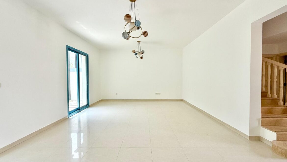 Exterior view of a four-bedroom Aegean-style villa in Western Residence North, Falcon City of Wonders, Dubai, featuring modern architecture and lush landscaping.-Propertyana real estate in dubai and sharjeh