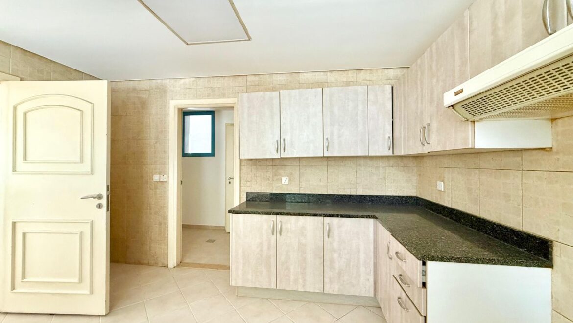 Exterior view of a four-bedroom Aegean-style villa in Western Residence North, Falcon City of Wonders, Dubai, featuring modern architecture and lush landscaping.-Propertyana real estate in dubai and sharjeh