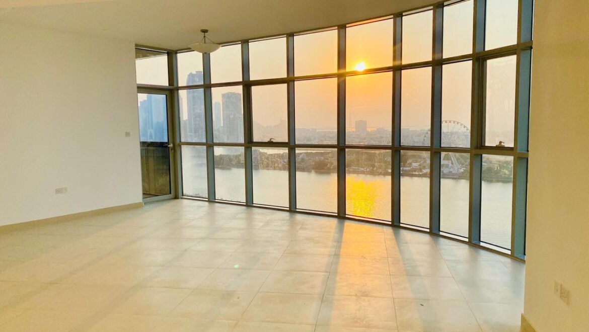 Interior view of a luxury 3-bedroom apartment in Al Majaz 1, Sharjah, featuring a spacious living area with modern furnishings and expansive sea-facing windows.-Propertyana real estate in dubai and sharjeh