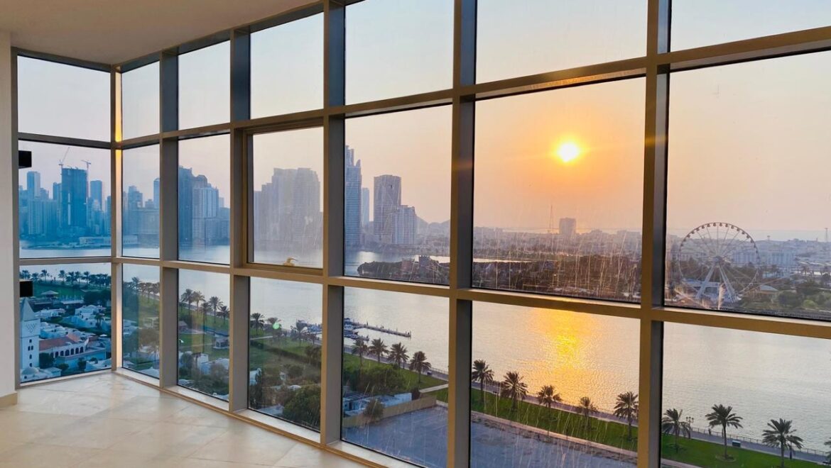 Interior view of a luxury 3-bedroom apartment in Al Majaz 1, Sharjah, featuring a spacious living area with modern furnishings and expansive sea-facing windows.-Propertyana real estate in dubai and sharjeh