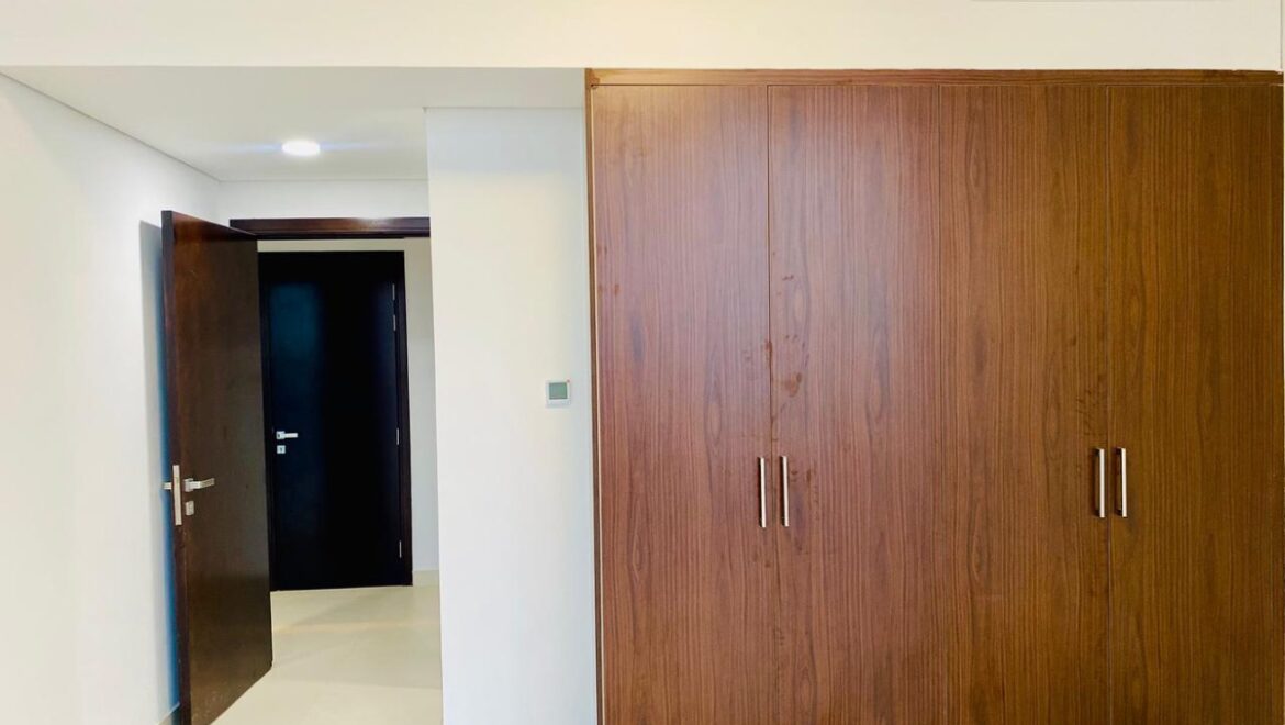 Interior view of a luxury 3-bedroom apartment in Al Majaz 1, Sharjah, featuring a spacious living area with modern furnishings and expansive sea-facing windows.-Propertyana real estate in dubai and sharjeh