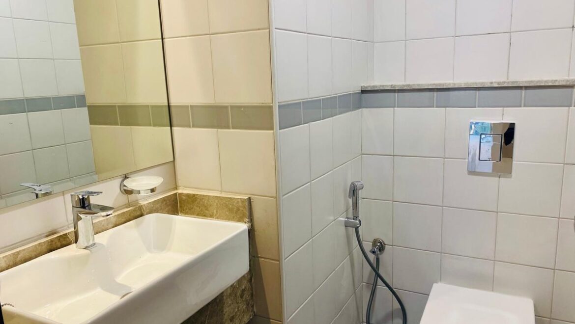 Interior view of a luxury 3-bedroom apartment in Al Majaz 1, Sharjah, featuring a spacious living area with modern furnishings and expansive sea-facing windows.-Propertyana real estate in dubai and sharjeh