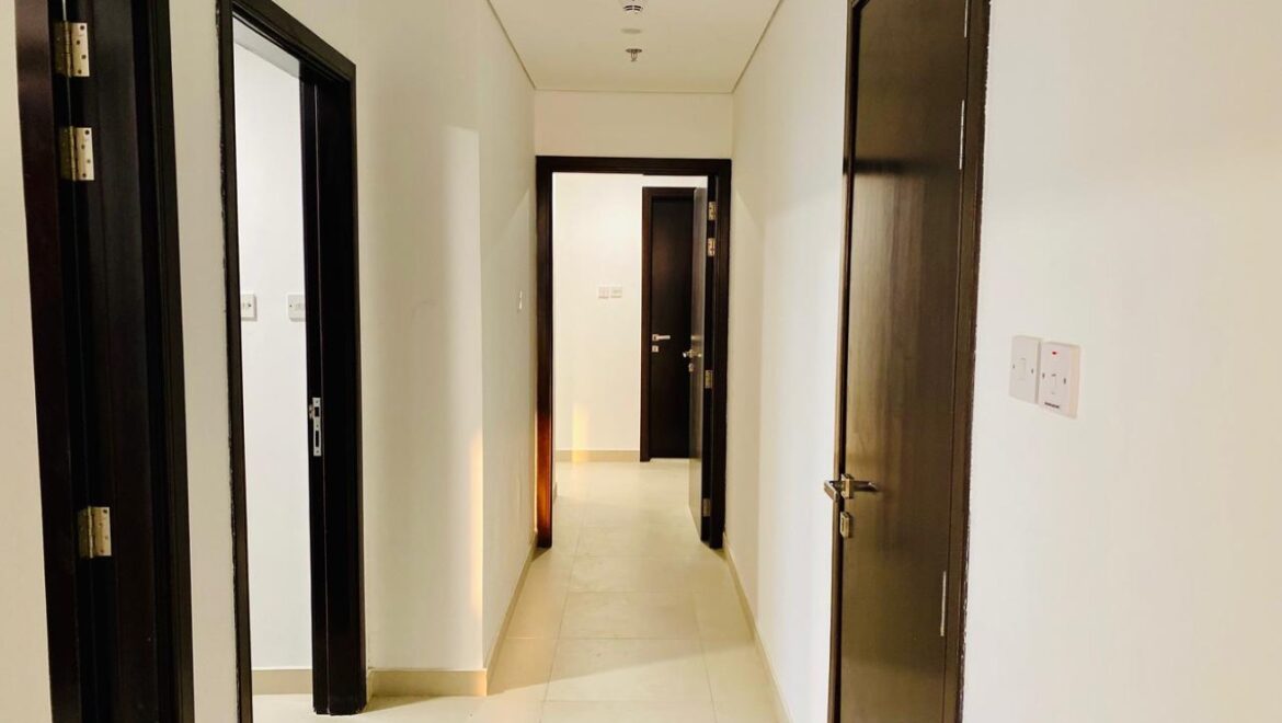 Interior view of a luxury 3-bedroom apartment in Al Majaz 1, Sharjah, featuring a spacious living area with modern furnishings and expansive sea-facing windows.-Propertyana real estate in dubai and sharjeh