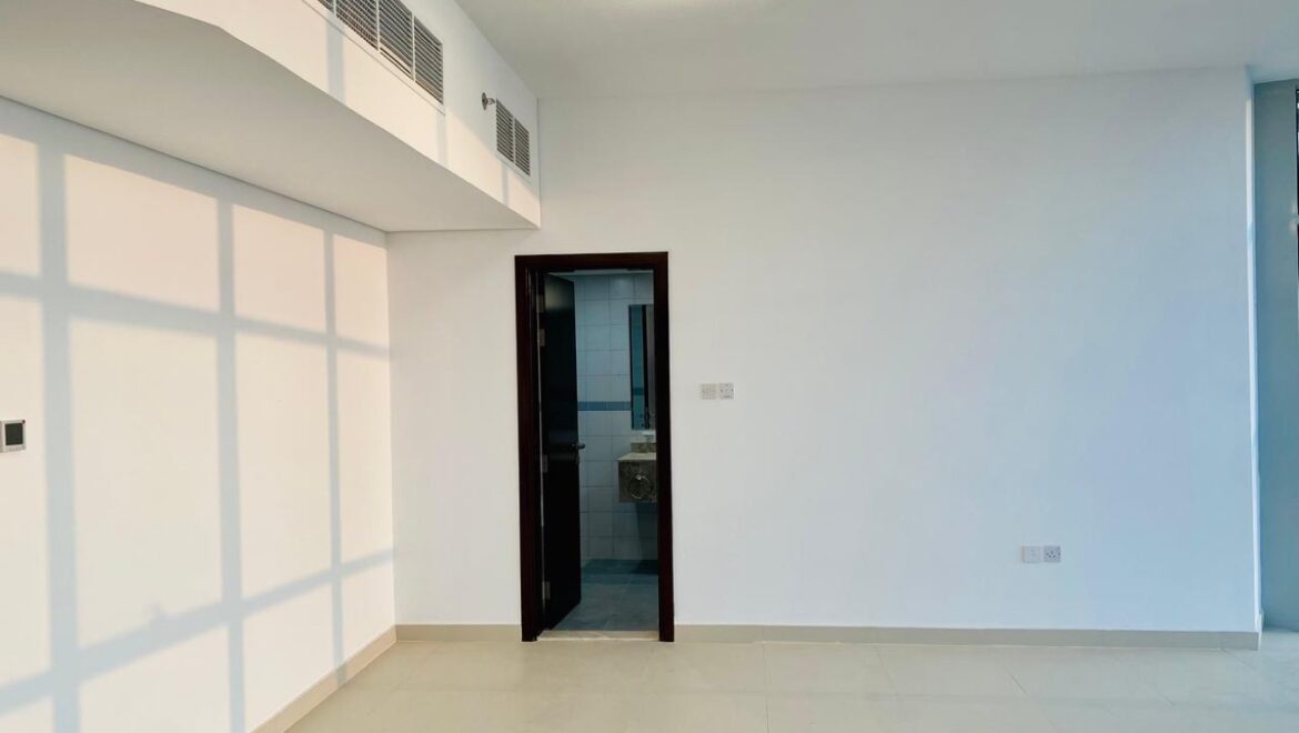 Interior view of a luxury 3-bedroom apartment in Al Majaz 1, Sharjah, featuring a spacious living area with modern furnishings and expansive sea-facing windows.-Propertyana real estate in dubai and sharjeh