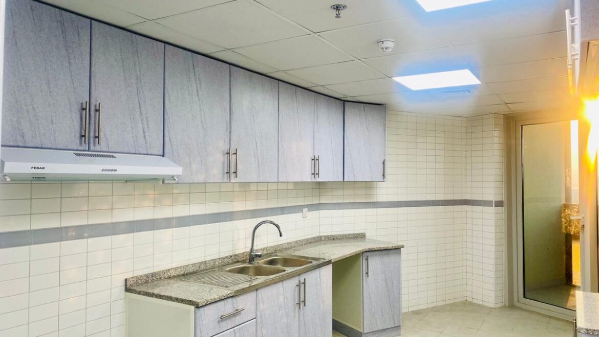 Interior view of a luxury 3-bedroom apartment in Al Majaz 1, Sharjah, featuring a spacious living area with modern furnishings and expansive sea-facing windows.-Propertyana real estate in dubai and sharjeh