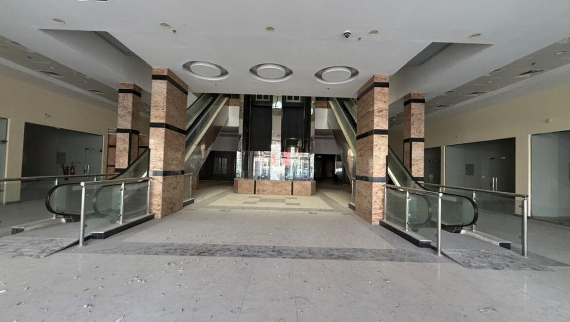 Modern bedroom interior with a queen bed, nightstands and warm ambient lighting, shown as an interior concept for Rolla Square Mall in Sharjah's Rolla Area.-Propertyana real estate in dubai and sharjeh