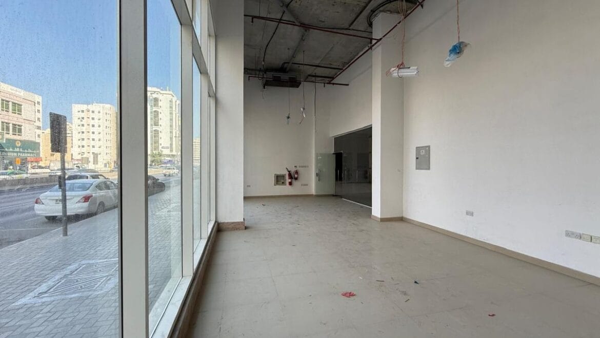 Modern bedroom interior with a queen bed, nightstands and warm ambient lighting, shown as an interior concept for Rolla Square Mall in Sharjah's Rolla Area.-Propertyana real estate in dubai and sharjeh