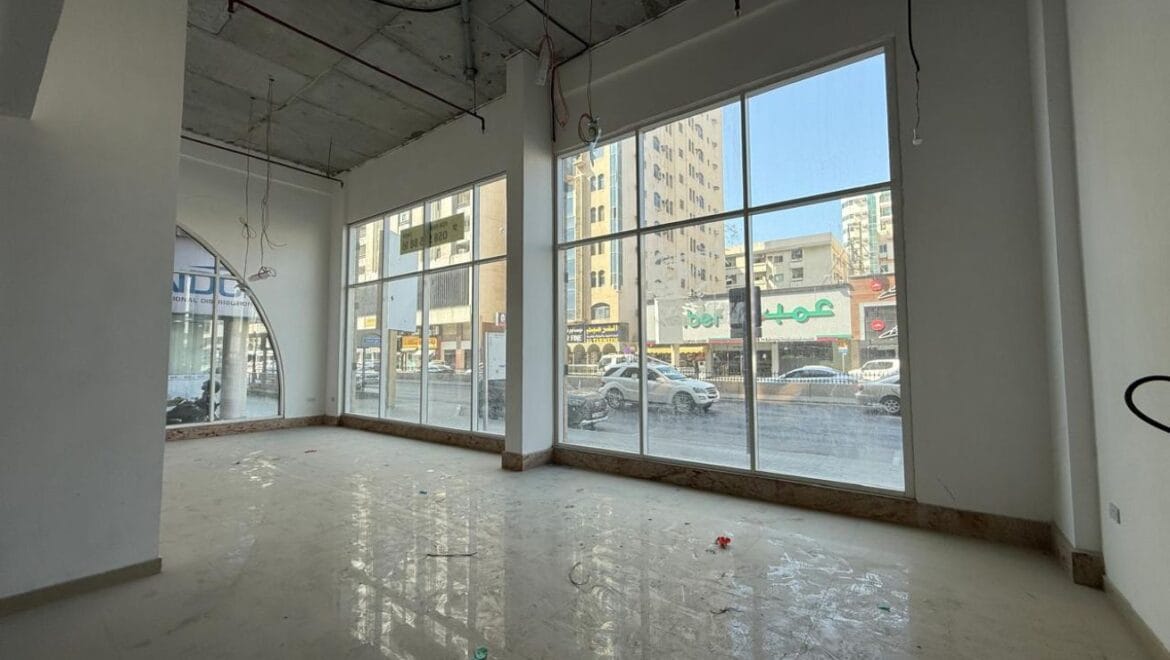 Modern bedroom interior with a queen bed, nightstands and warm ambient lighting, shown as an interior concept for Rolla Square Mall in Sharjah's Rolla Area.-Propertyana real estate in dubai and sharjeh