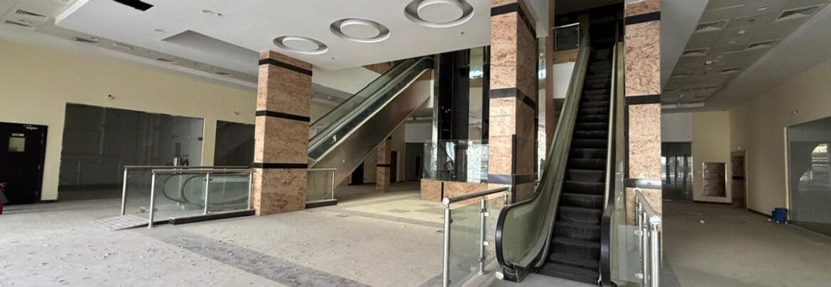 Modern bedroom interior with a queen bed, nightstands and warm ambient lighting, shown as an interior concept for Rolla Square Mall in Sharjah's Rolla Area.-Propertyana real estate in dubai and sharjeh