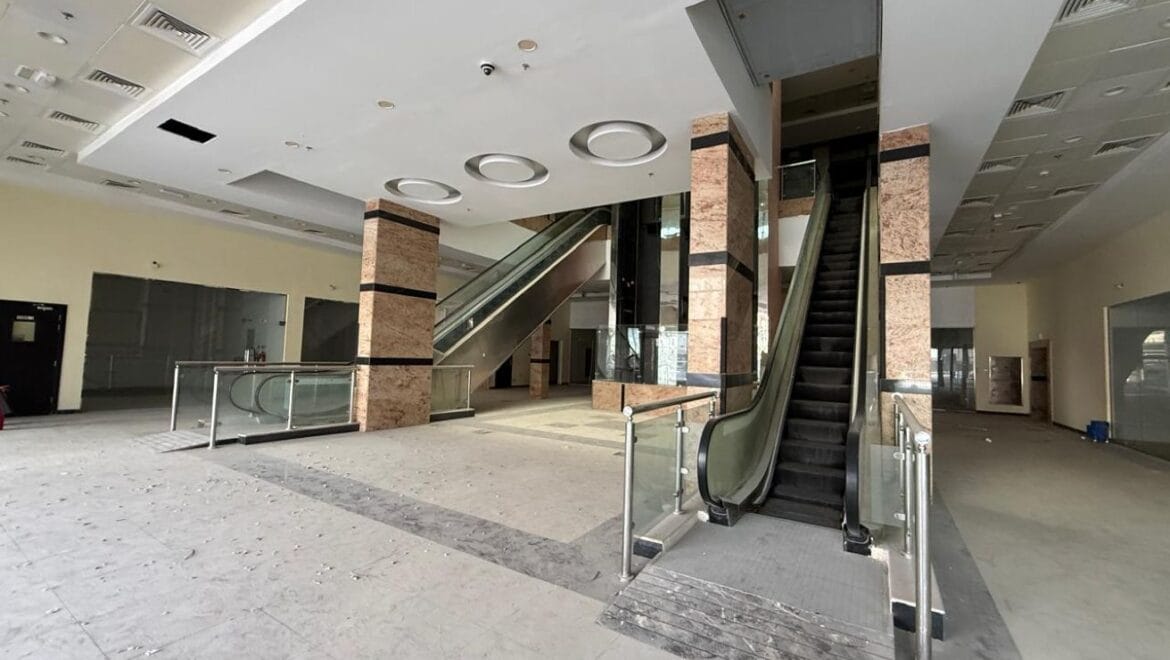 Modern bedroom interior with a queen bed, nightstands and warm ambient lighting, shown as an interior concept for Rolla Square Mall in Sharjah's Rolla Area.-Propertyana real estate in dubai and sharjeh