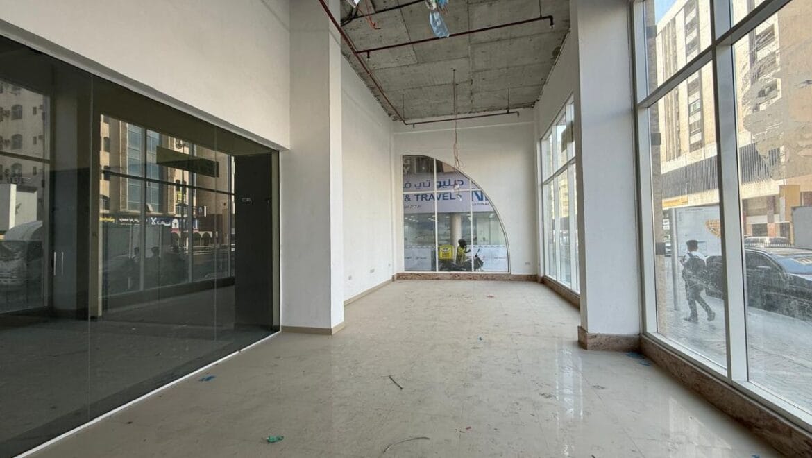 Modern bedroom interior with a queen bed, nightstands and warm ambient lighting, shown as an interior concept for Rolla Square Mall in Sharjah's Rolla Area.-Propertyana real estate in dubai and sharjeh