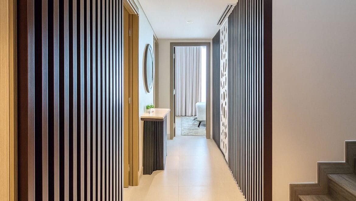 Exterior view of a modern, upgraded 4-bedroom waterfront townhouse in Ajmal Makan City within Sharjah Waterfront City, featuring private beach access.-Propertyana real estate in dubai and sharjeh