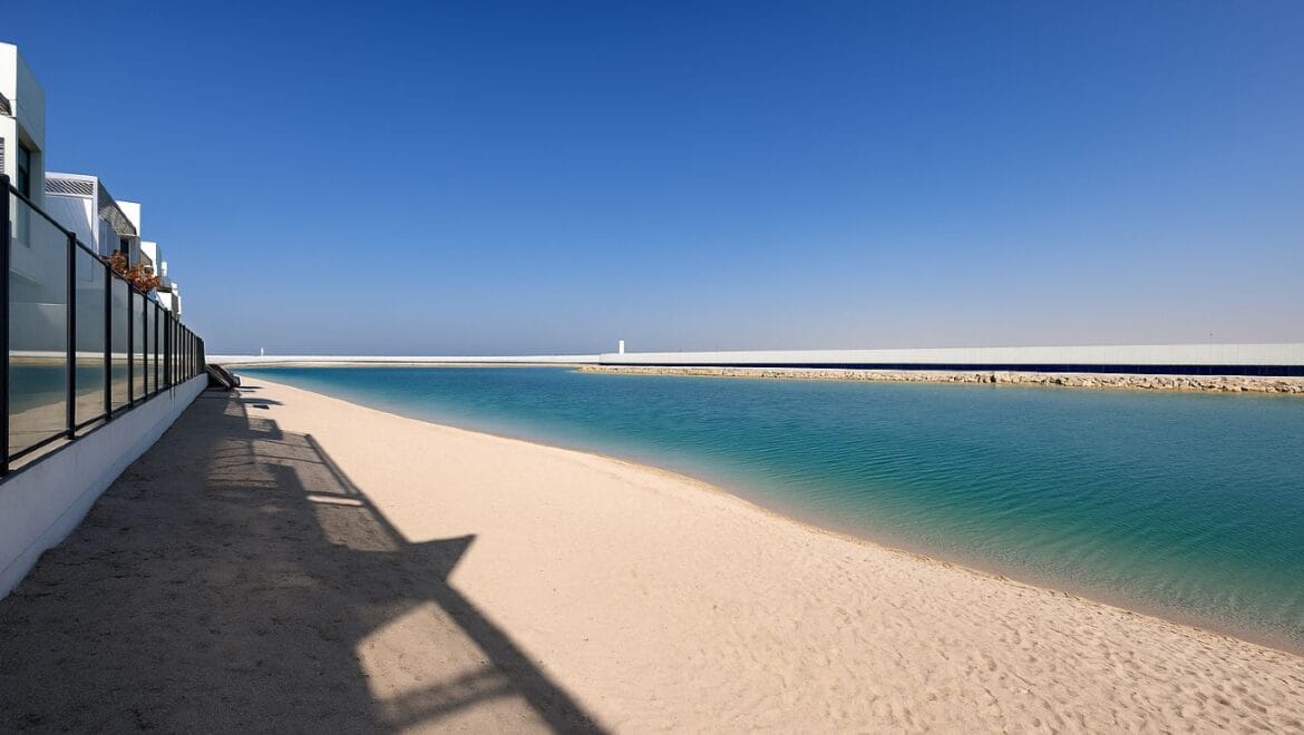 Exterior view of a modern, upgraded 4-bedroom waterfront townhouse in Ajmal Makan City within Sharjah Waterfront City, featuring private beach access.-Propertyana real estate in dubai and sharjeh