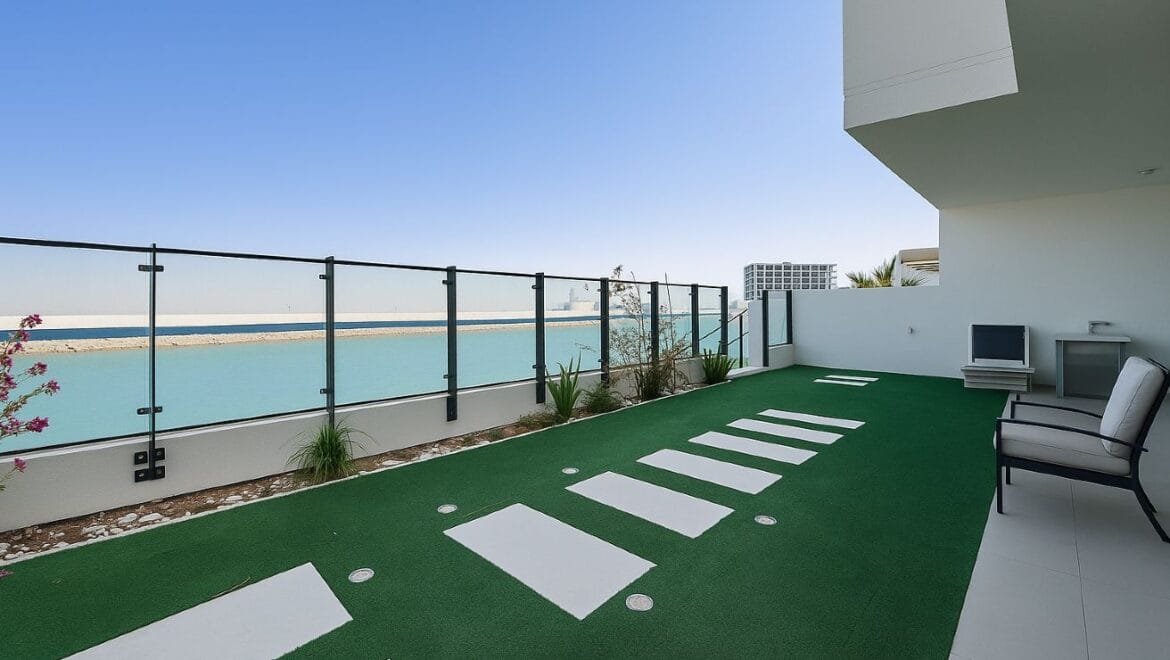 Exterior view of a modern, upgraded 4-bedroom waterfront townhouse in Ajmal Makan City within Sharjah Waterfront City, featuring private beach access.-Propertyana real estate in dubai and sharjeh