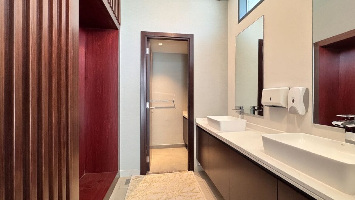 Exterior view of a modern, upgraded 4-bedroom waterfront townhouse in Ajmal Makan City within Sharjah Waterfront City, featuring private beach access.-Propertyana real estate in dubai and sharjeh