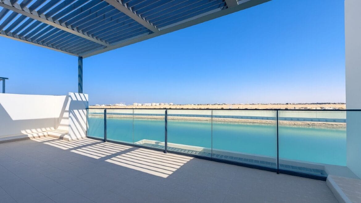 Exterior view of a modern, upgraded 4-bedroom waterfront townhouse in Ajmal Makan City within Sharjah Waterfront City, featuring private beach access.-Propertyana real estate in dubai and sharjeh