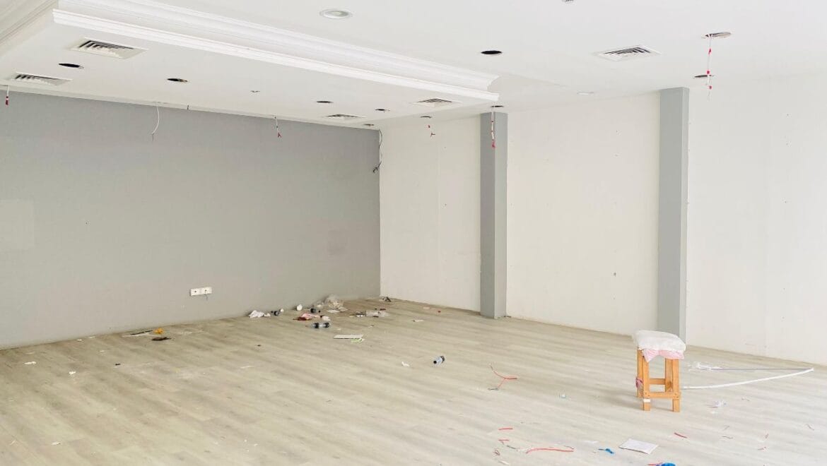 Interior view of a modern bedroom showroom inside a commercial retail space in Al Nabba, Sharjah, featuring a neatly made bed, neutral tones, and contemporary furnishings.-Propertyana real estate in dubai and sharjeh