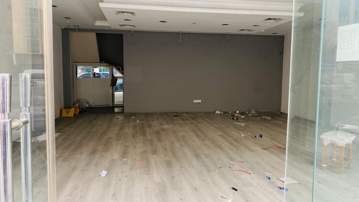 Interior view of a modern bedroom showroom inside a commercial retail space in Al Nabba, Sharjah, featuring a neatly made bed, neutral tones, and contemporary furnishings.-Propertyana real estate in dubai and sharjeh