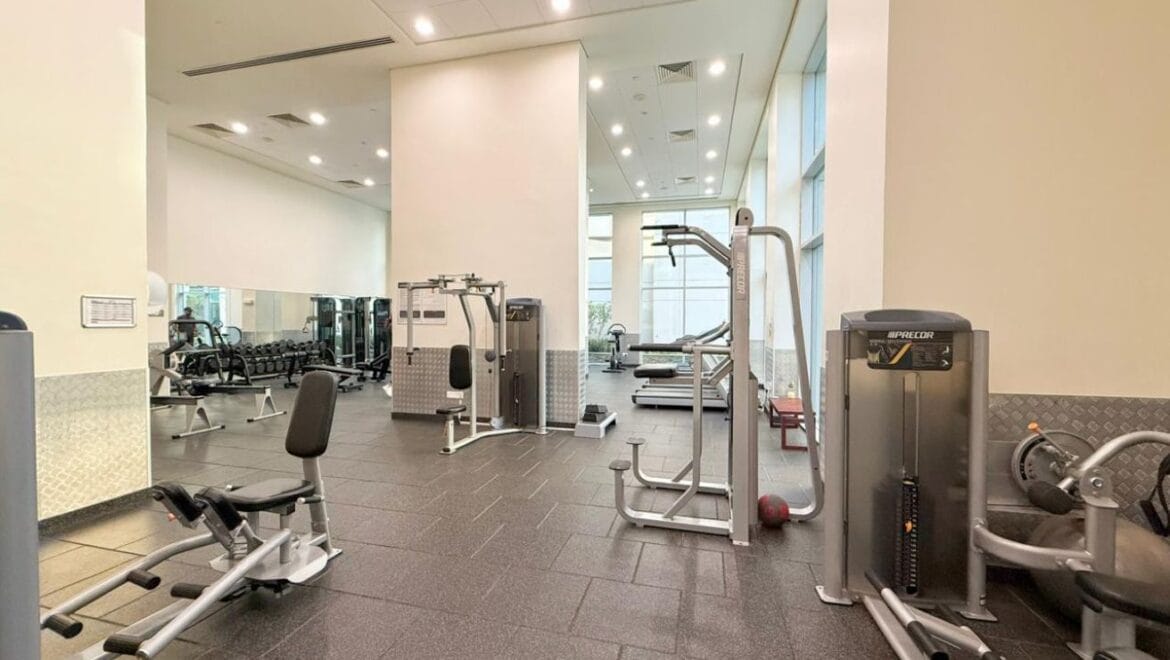 Studio bedroom interior in a residential apartment at Burj Views Podium, Downtown Dubai, featuring modern furnishings and a large window with city skyline views.-Propertyana real estate in dubai and sharjeh