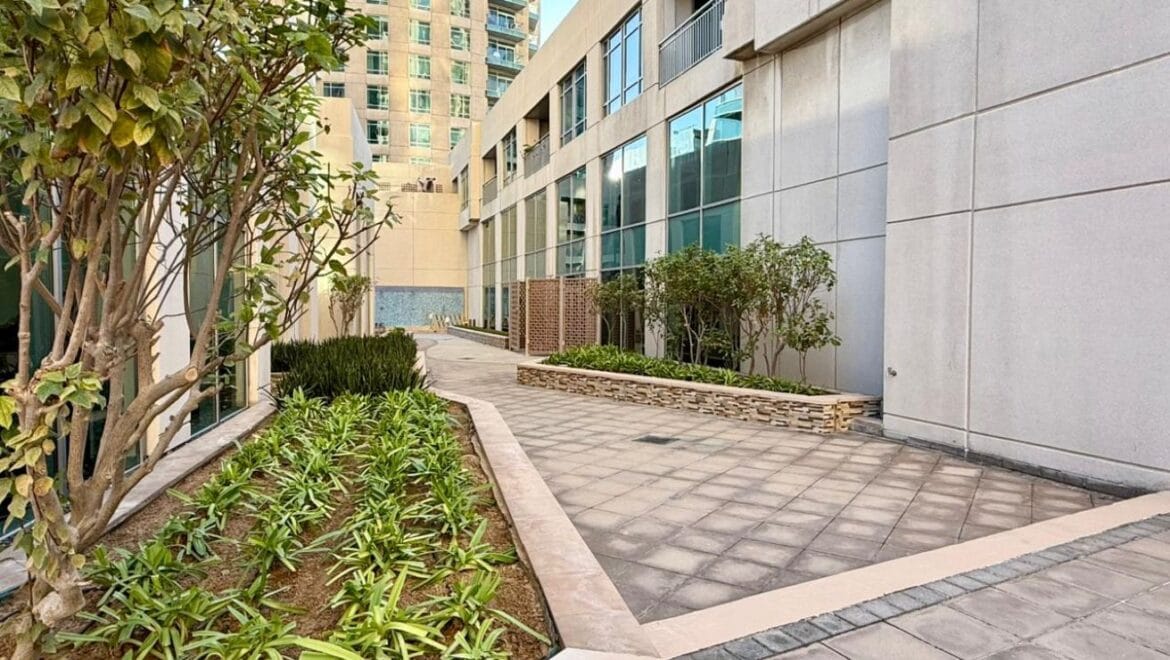 Studio bedroom interior in a residential apartment at Burj Views Podium, Downtown Dubai, featuring modern furnishings and a large window with city skyline views.-Propertyana real estate in dubai and sharjeh