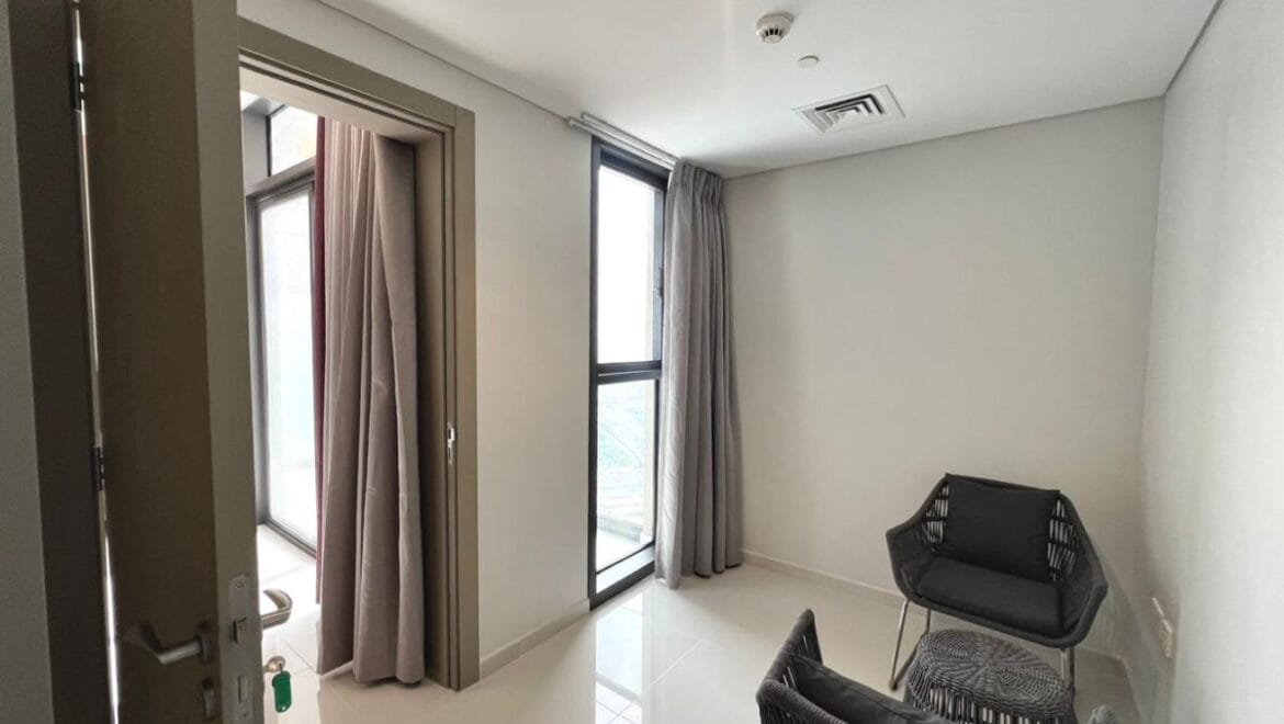 Studio bedroom in a luxury residential apartment at Aykon City Tower B, Business Bay, Dubai, featuring contemporary decor, a compact study area, and large windows with skyline views.-Propertyana real estate in dubai and sharjeh