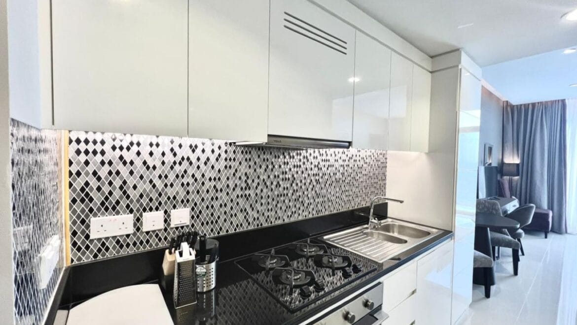 Studio bedroom in a luxury residential apartment at Aykon City Tower B, Business Bay, Dubai, featuring contemporary decor, a compact study area, and large windows with skyline views.-Propertyana real estate in dubai and sharjeh