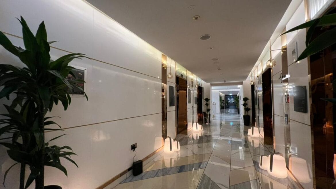 Studio bedroom in a luxury residential apartment at Aykon City Tower B, Business Bay, Dubai, featuring contemporary decor, a compact study area, and large windows with skyline views.-Propertyana real estate in dubai and sharjeh