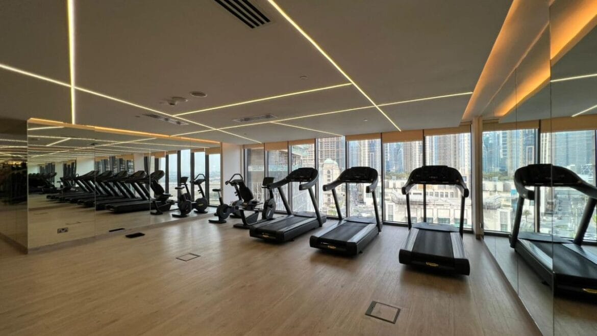 Studio bedroom in a luxury residential apartment at Aykon City Tower B, Business Bay, Dubai, featuring contemporary decor, a compact study area, and large windows with skyline views.-Propertyana real estate in dubai and sharjeh