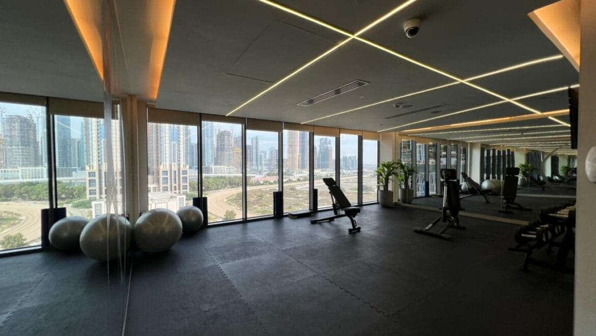 Studio bedroom in a luxury residential apartment at Aykon City Tower B, Business Bay, Dubai, featuring contemporary decor, a compact study area, and large windows with skyline views.-Propertyana real estate in dubai and sharjeh